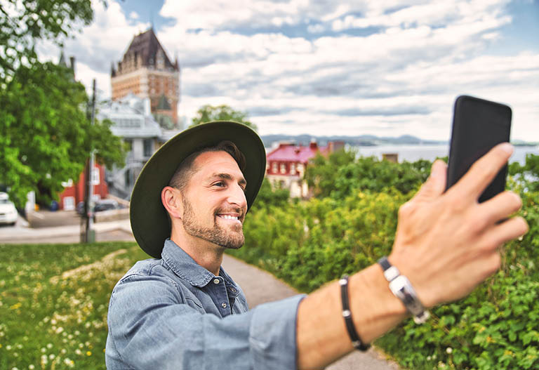 Tourist taking selfie at Frontenac de Cheateau
