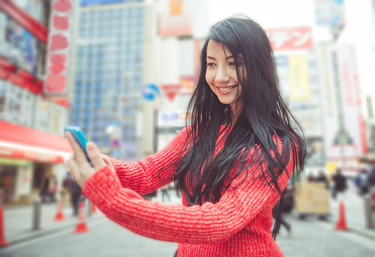 Woman taking selfie at Akihabara